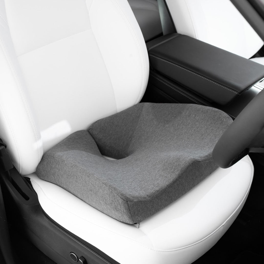 Grey Biggie's Seat Cushion from Fine Foams placed on Tesla's car seat.